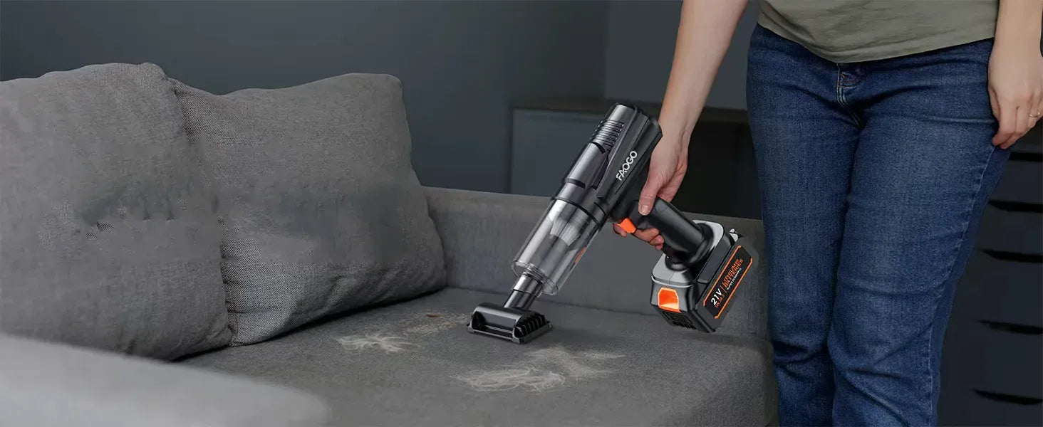 FAOGO 21V handheld vacuum removing pet hair from a grey sofa. Portable cordless cleaner for home furniture and upholstery.