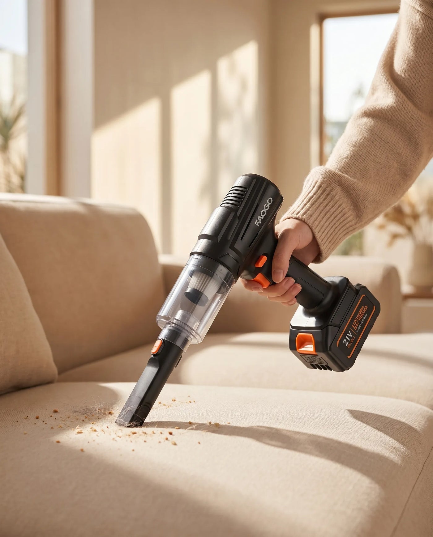 FAOGO 21V cordless upholstery vacuum cleaning crumbs from a fabric sofa using a crevice tool. Portable couch detailing gear.