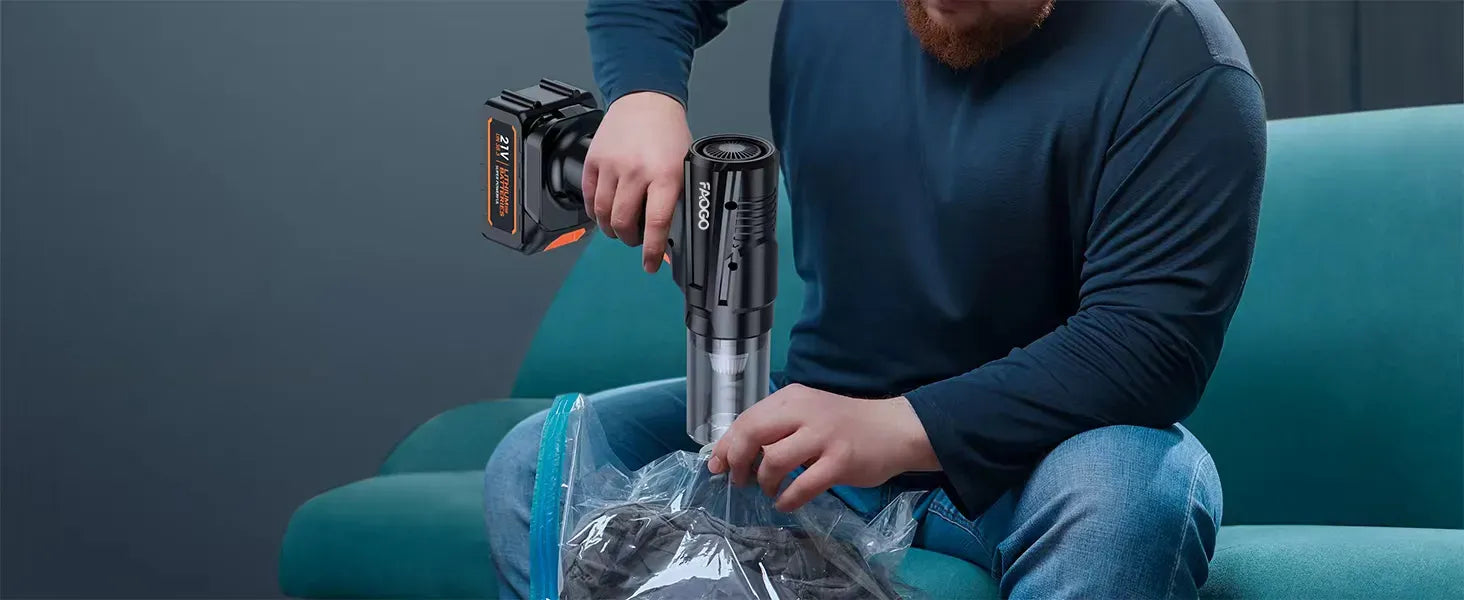 FAOGO 21V multi-functional tool vacuuming a storage bag for clothes. Handheld cordless sealer for space-saving home organization.