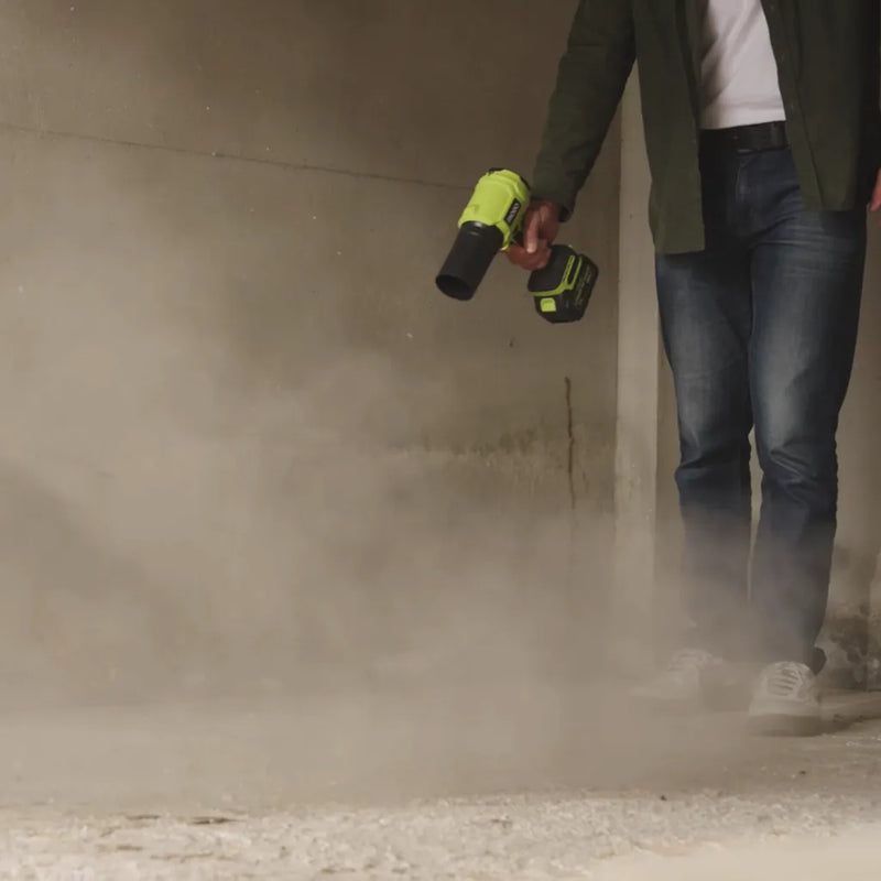 FAOGO cordless workshop blower clearing heavy dust from a concrete garage floor. Portable high speed sweeper for DIY cleanup.